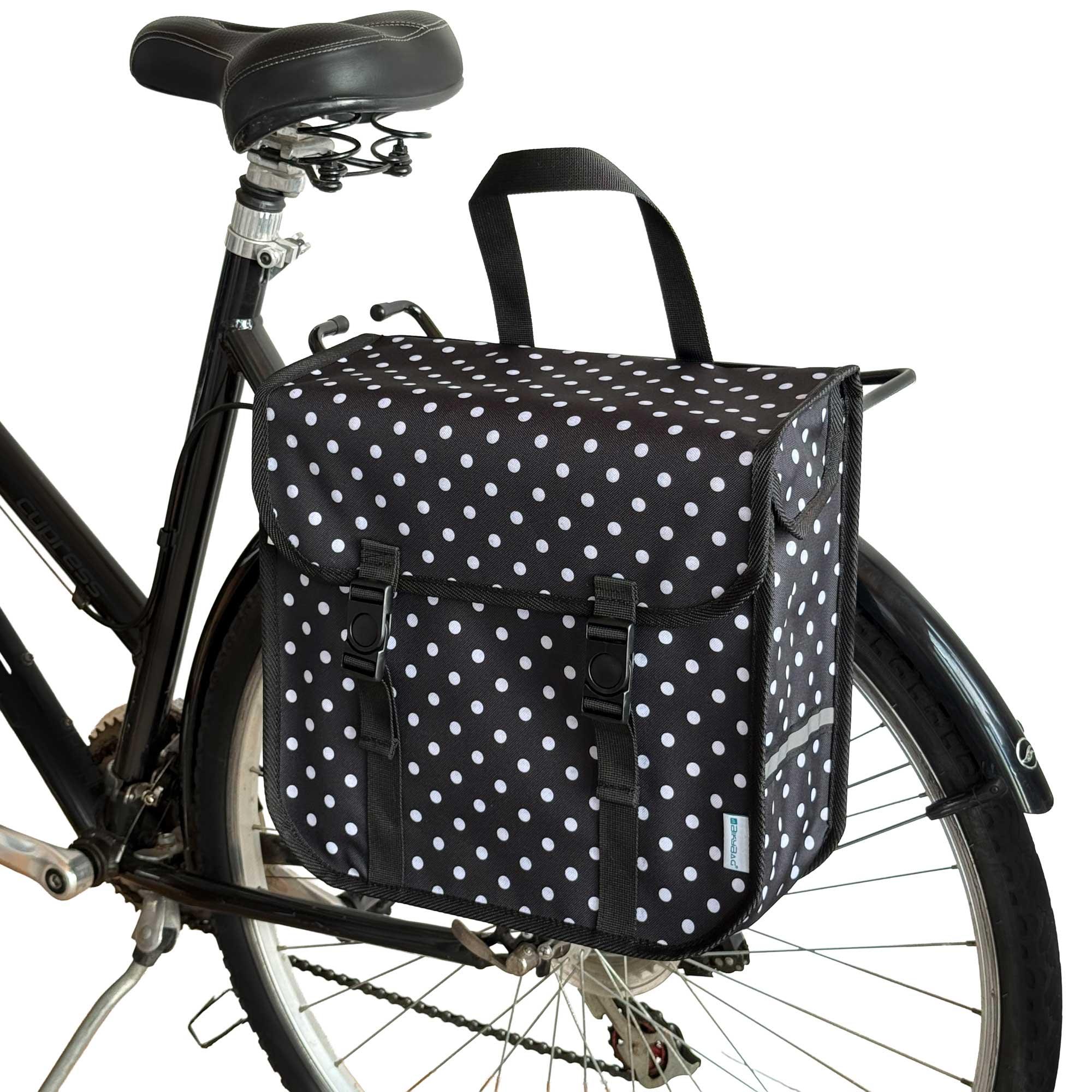 Black bicycle with a polka dot bag attached to the back