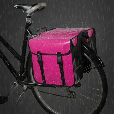 Pink bicycle saddle bag on a bike with raindrops on a dark background