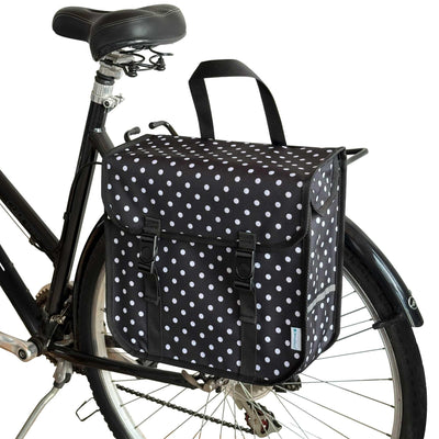 Black bicycle with a polka dot bag attached to the back